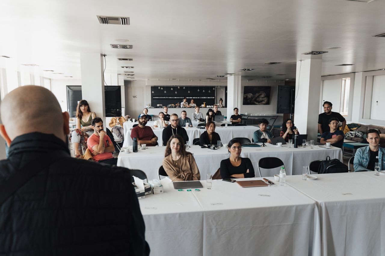A diverse group of business professionals attending a presentation in a modern conference room.